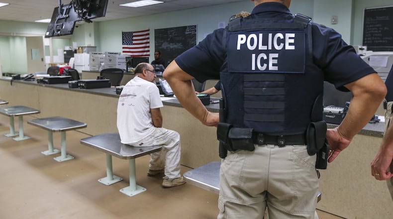 U.S. Immigration and Customs Enforcement officers detaining a Mexican national in Atlanta, Aug. 18, 2017. JOHN SPINK/JSPINK@AJC.COM