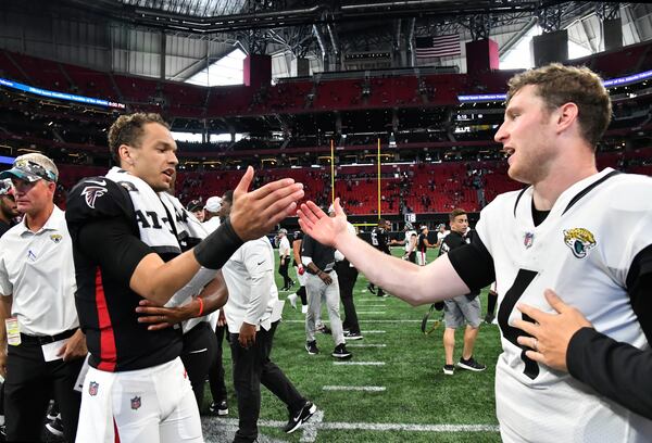 Falcons' quarterback Desmond Ridder (4) and Jacksonville Jaguars' quarterback E.J. Perry (4) shake hands after Atlanta Falcons won over Jacksonville Jaguars during the final exhibition game of the preseason at Mercedes-Benz Stadium in Atlanta at on Saturday, August 27, 2022. Atlanta Falcons won 28-12 over Jacksonville Jaguars. (Hyosub Shin / Hyosub.Shin@ajc.com)