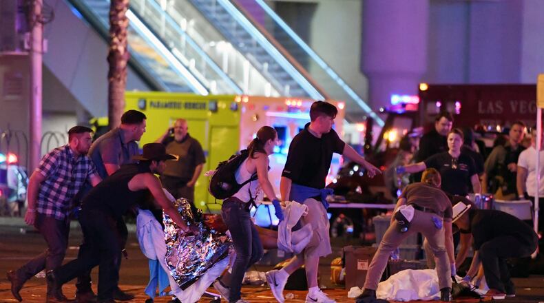 LAS VEGAS, NV - OCTOBER 02: An injured person is tended to in the intersection of Tropicana Ave. and Las Vegas Boulevard after a mass shooting at a country music festival nearby on October 2, 2017 in Las Vegas, Nevada. A gunman has opened fire on a music festival in Las Vegas, killing over 20 people. Police have confirmed that one suspect has been shot dead. The investigation is ongoing. (Photo by Ethan Miller/Getty Images)