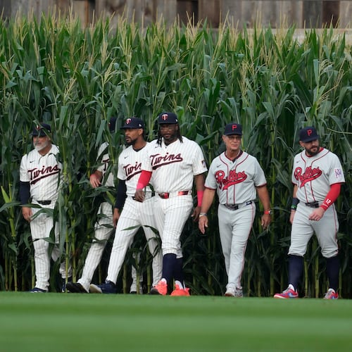 Players walk onto the field before a baseball game between the Minnesota Twins and the Philadelphia Phillies at the Field of Dreams movie site, Thursday, Aug. 13, 2026, in Dyersville, Iowa. (AP Photo/Charlie Neibergall)