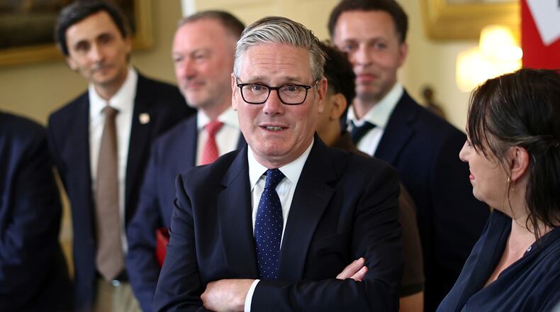 Britain's Prime Minister Keir Starmer, center, speaks with people whose lives who are said to have been improved by the Labour Government, during a meeting inside 10 Downing Street, central London, Wednesday July 15, 2026. (Henry Nicholls/Pool Photo via AP)