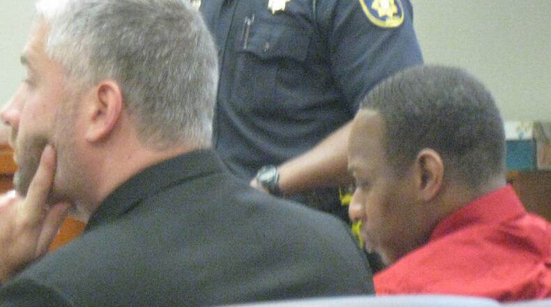 Quentric Williams is escorted from a DeKalb County courtroom during a break in his murder trial. Williams is accused of killing martial arts expert Mitt Lenix in the early morning hours of May 15, 2012, at the Starlight Drive-in theater on Moreland Drive. Then, prosecutors say, he led police on a high-speed chase through DeKalb County to Gwinnett.Quentric Williams, right, sits with his attorney Russell Z. Hetzel as a police officer testifies during Williams’ murder trial. Williams is accused of killing martial arts expert Mitt Lenix in the early morning hours of May 15, 2012, at the Starlight Drive-in theater on Moreland Drive. Then, prosecutors say, he led police on a high-speed chase through DeKalb County to Gwinnett.