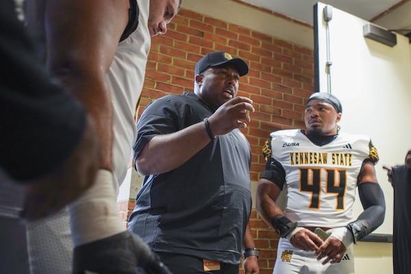 Baron Hopson (right) listens to coach Jerry Mack's instructions before Kennesaw State's season opener at Wake Forest. (Kennesaw State Athletics)