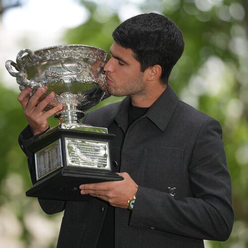 Carlos Alcaraz of Spain kisses the Norman Brookes Challenge Cup the morning after defeating Novak Djokovic of Serbia in the men's singles final at the Australian Open tennis championship, in Melbourne, Australia, Monday, Feb. 2, 2026. (AP Photo/Dita Alangkara)