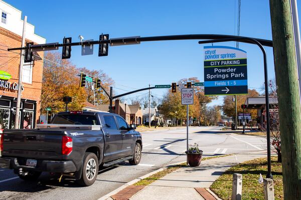 People drive through Marietta Street corridor in Powder Springs, Georgia, on Thursday, December 10, 2020. Powder Springs is embarking on a plan that would allow more businesses and mixed-used residences to possibly open in its downtown. The city's plan hopes to promote growth and redevelopment while maintaining its small-town charm and atmosphere. (Rebecca Wright for the Atlanta Journal-Constitution)  