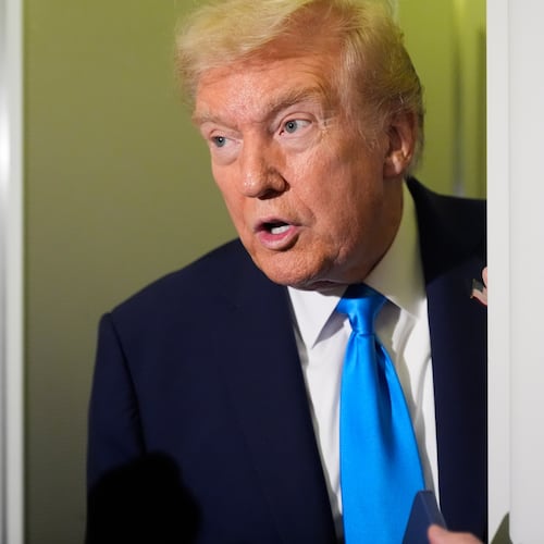 President Donald Trump speaks with reporters aboard Air Force One at Al Udeid Air Base in Doha, Qatar, Saturday, Oct. 25, 2025. (AP Photo/Mark Schiefelbein)