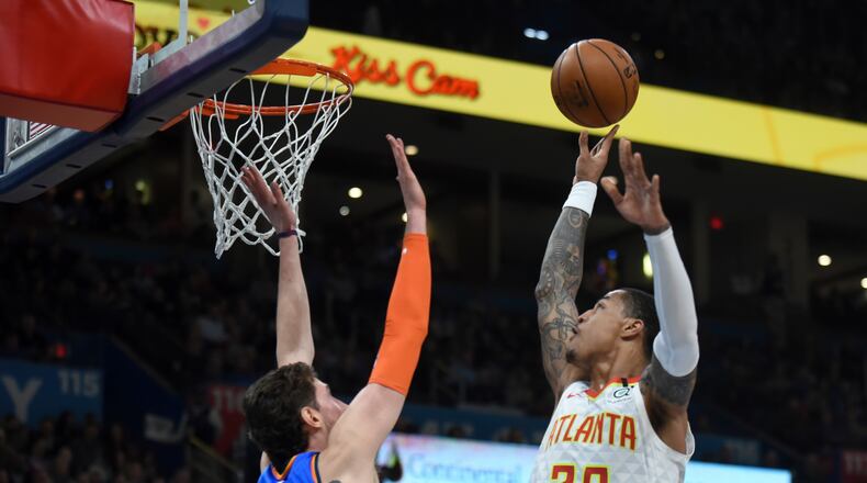 Atlanta Hawks forward John Collins (20) shoots over Oklahoma City Thunder forward Mike Muscala (33) in the first half of an NBA basketball game Friday, Jan. 24, 2020, in Oklahoma City. (AP Photo/Kyle Phillips)
