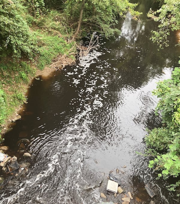 A photo of the South River near Forrest Park Road shows black water flowing on Sept. 6, 2024. State environmental officials have confirmed that they are investigating the pollution incident, which local water advocates say caused a fish kill.