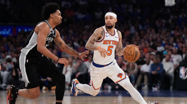 New York Knicks guard Jose Alvarado (5) drives as San Antonio Spurs guard Dylan Harper defend during the first half of Game 4 of the NBA Finals basketball series, Wednesday, June 10, 2026, in New York. (AP Photo/Ross D. Franklin)