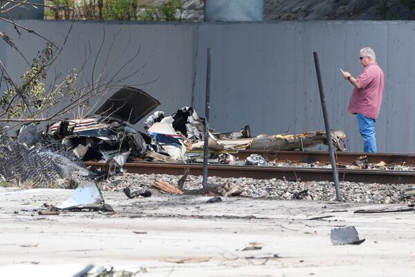 Emergency crew inspects the site of a small plane crash Friday, April 11, 2025 in Boca Raton, Fla. (AP Photo/Marta Lavandier)