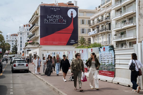 People walk along the Boulevard de la Croisette ahead of the 78th international film festival in Cannes, southern France, Sunday, May 11, 2025. The Cannes film festival runs from May 13 until May 24, 2025. (AP Photo/Lewis Joly)
