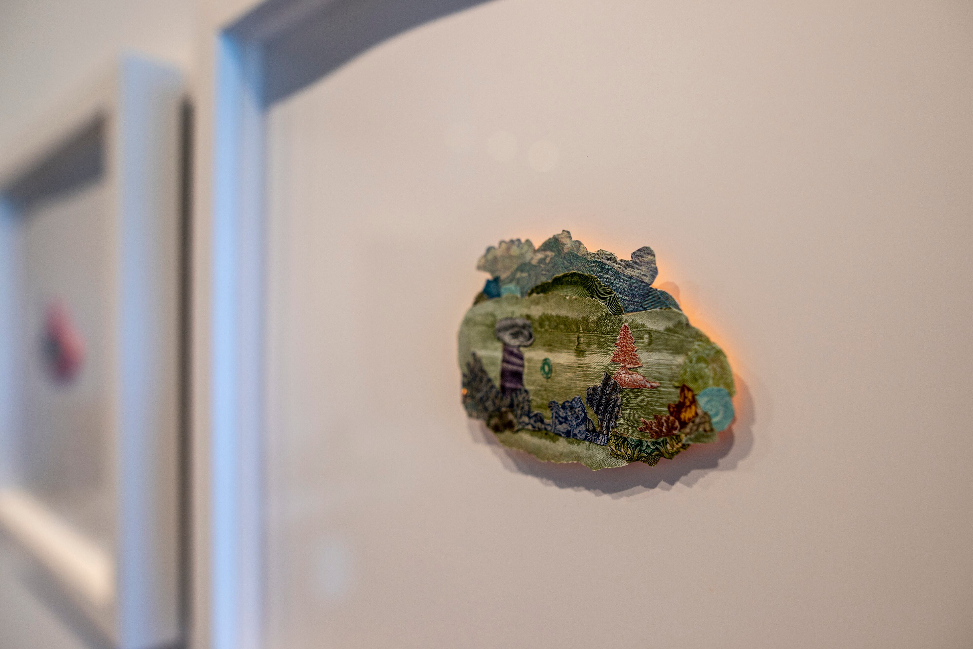 "INSTAR" includes small works of collage and paint that Pam Longobardi created from defunct and devalued currency. She enjoys collecting obsolete currency from other countries, and then cutting it up and carefully layering it into miniature vistas. (Courtesy of Isadora Pennington)