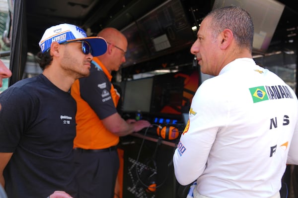 Kyle Larson talks with Tony Kanaan, of Brazil, after Kanaan completed his refresher test during practice for the Indianapolis 500 auto race at Indianapolis Motor Speedway in Indianapolis, Thursday, May 15, 2025. (AP Photo/Michael Conroy)