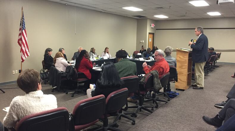 DeKalb County Commissioner Jeff Rader (right) speaks to the county Board of Registration and Elections on Thursday. (Photo by J.D. Capelouto)
