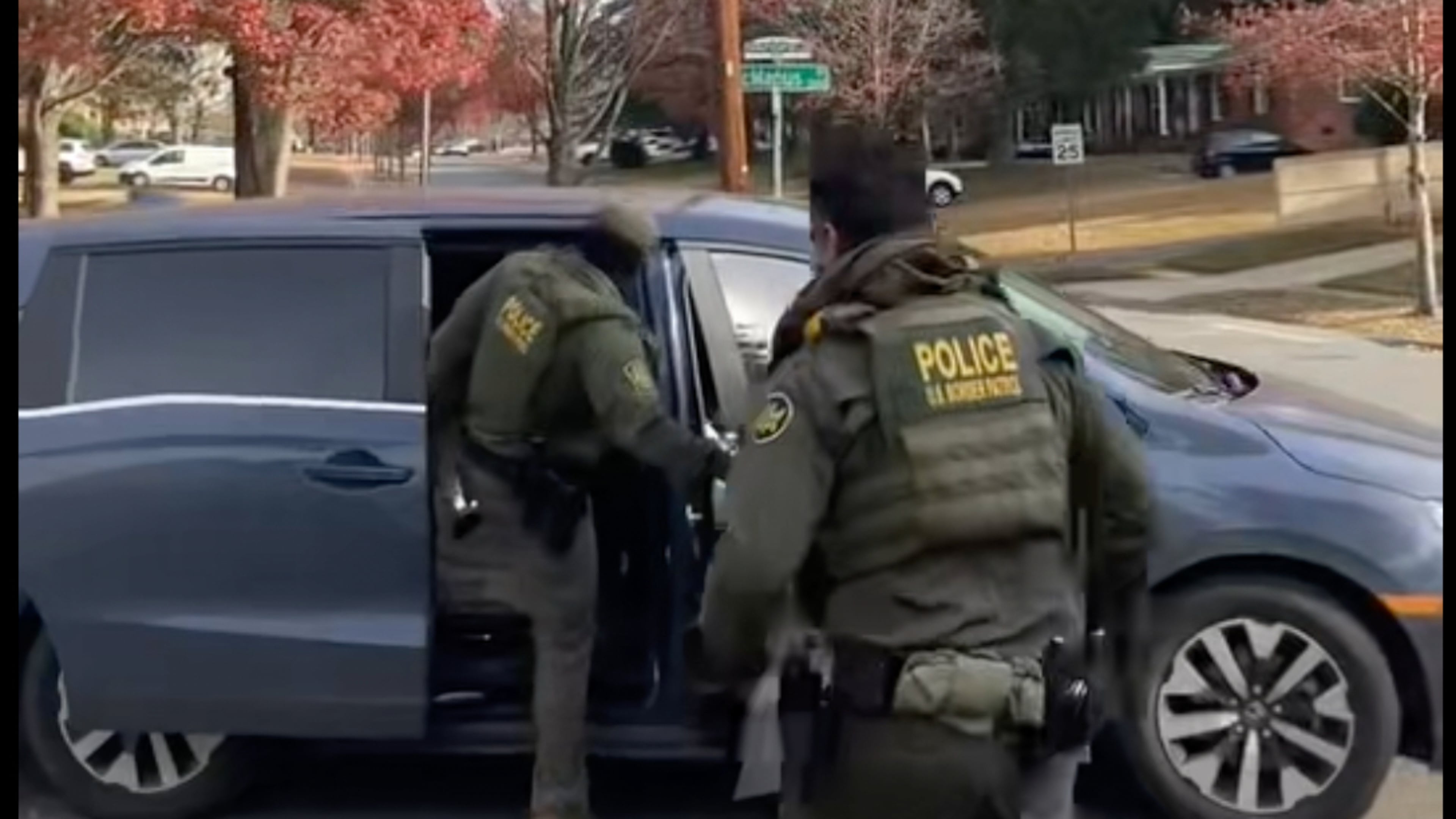 This image taken from video provided by Rheba Hamilton shows U.S. Border Patrol agents leave a year after approaching two men hanging lights in Charlotte, N.C. on Saturday, Nov 15, 2025. (Rheba Hamilton via AP)