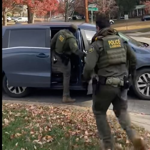 This image taken from video provided by Rheba Hamilton shows U.S. Border Patrol agents leave a year after approaching two men hanging lights in Charlotte, N.C. on Saturday, Nov 15, 2025. (Rheba Hamilton via AP)