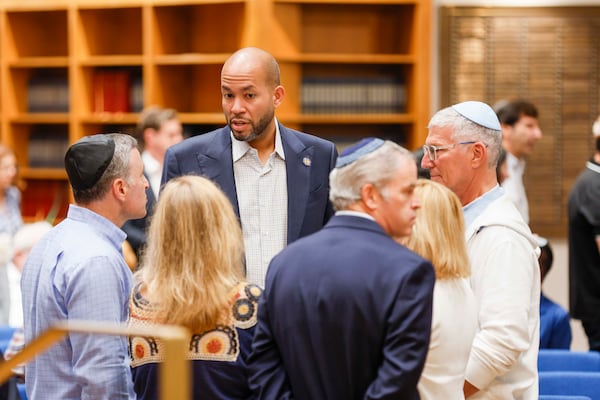 Democratic gubernatorial candidate Jason Esteves is seen talking with members of the Jewish community at the Ahavath Achim Synagogue as the community gathers on Sunday, October 5, 2025, to commemorate the second anniversary of the Oct. 7 attacks.
(Miguel Martinez/ AJC)