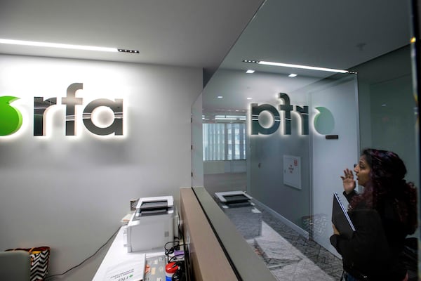 A woman walks past the empty receptionist desk at Radio Free Asia, Tuesday, April 1, 2025, in Washington. (AP Photo/Rod Lamkey, Jr.)