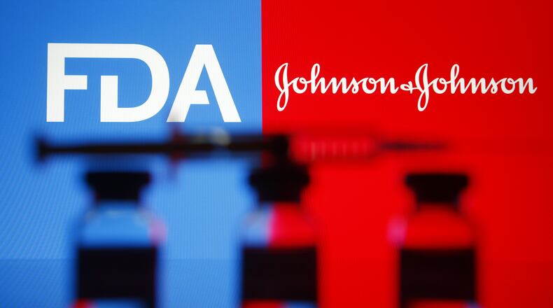 In this photo illustration Food and Drug Administration and Johnson & Johnson logos are seen in front of a medical syringe and vials. (Pavlo Gonchar/SOPA Images via ZUMA Wire/TNS)