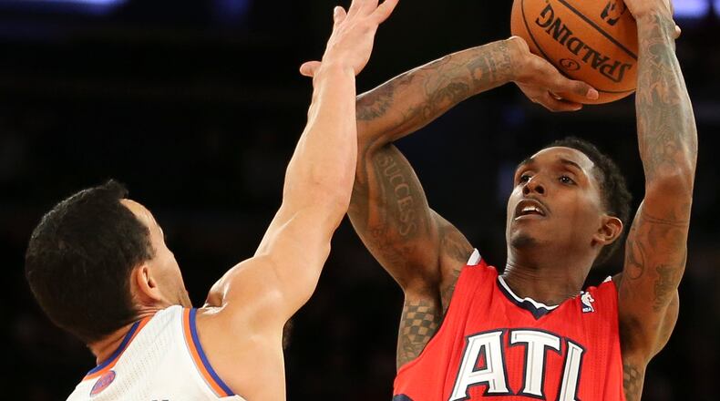 Atlanta Hawks shooting guard Louis Williams (3) shoots over New York Knicks point guard Pablo Prigioni (9) during the second half of an NBA basketball game Saturday, Dec. 14, 2013, in New York. The Knicks won 111-106. (AP Photo/John Minchillo)