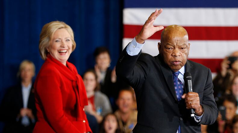 Democratic presidential candidate Hillary Clinton takes the stage with U.S. Rep. John Lewis, D-Ga., right, during a rally Sunday in Las Vegas. AP/John Locher