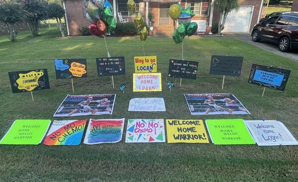 Signs on the front lawn greeted Model student Logan Knight as he returned home from months of cancer treatment in Atlanta. (Family Handout)