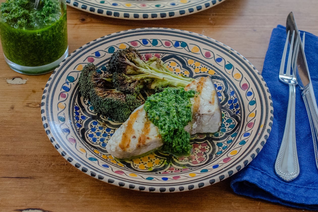 Grilled swordfish steak topped with zesty chermoula sauce, shown here with roasted broccoli, is an easy heart-healthy entree. (Virginia Willis for the AJC)