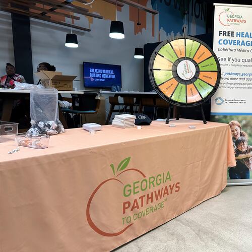 FILE - A stand for Georgia Pathways is seen at a job fair in Atlanta, Ga., June 5, 2025. (AP Photo/Sudhin Thanawala, File)