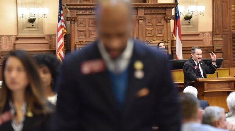 Democrats turn their backs on state Rep. Ed Setzler (right), an Acworth Republican, as he speaks about his legislation that would outlaw abortions once a doctor can detect a heartbeat in the womb. Hyosub Shin / Hyosub.Shin@ajc.com
