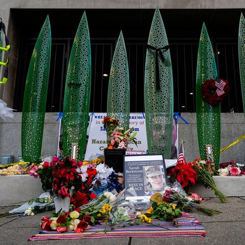 A makeshift memorial for U.S. Army Spc. Sarah Beckstrom and U.S. Air Force Staff Sgt. Andrew Wolfe is seen outside of Farragut West Station, near the site where the two National Guard members were shot, Monday, Dec. 1, 2025, in Washington. (AP Photo/Julia Demaree Nikhinson)