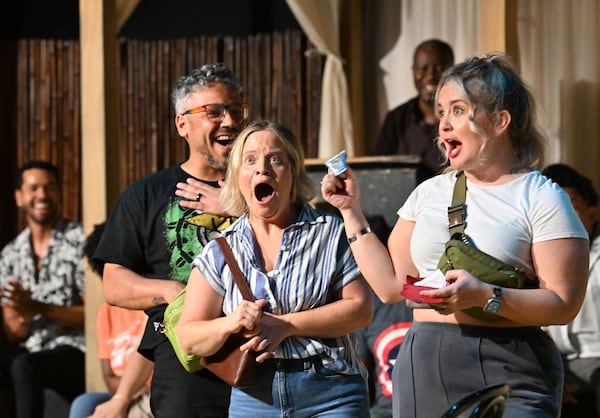Maged Roushdi (from left), Karen Cassady and Whittney Millsap improvise a sketch based on items they pulled out of audience members' bags during Friday night's TheatreSports competition at Dad's Garage. (Hyosub Shin/AJC)