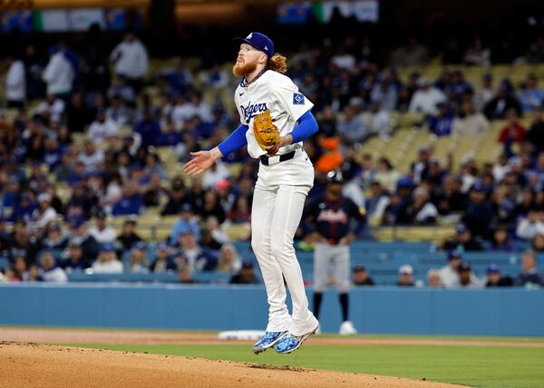 Los Angeles Dodgers' Dustin May jumps in the air after striking out the side against the Atlanta Braves during the first inning of a baseball game Tuesday, April 1, 2025, in Los Angeles. (AP Photo/Kevork Djansezian)