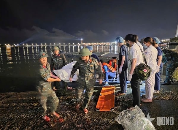 This image from a video provided by QDND shows a body being carried on stretcher after a tourist boat capsized in Ha Long Bay, Vietnam on Saturday, July 19, 2025. (QDND via AP)