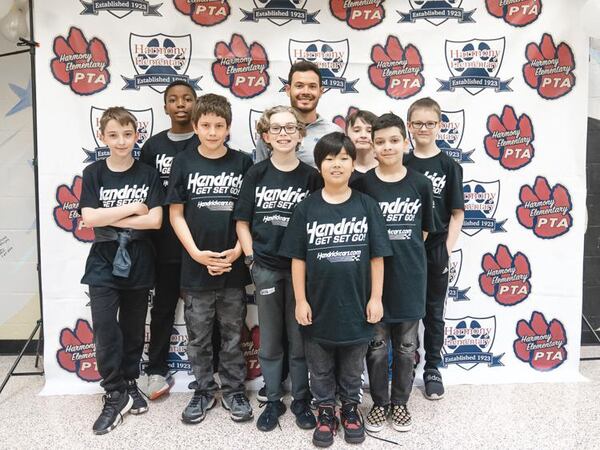 NASCAR Cup Series champion Kyle Larson poses for a photo with Harmony Elementary students. (Courtesy of Sheer+Candid)