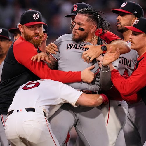 Washington Nationals' Andrés Chaparro, center, is held back as tempers flare during the fourth inning of a baseball game against the Boston Red Sox, Tuesday, June 30, 2026, in Boston. (AP Photo/Charles Krupa)