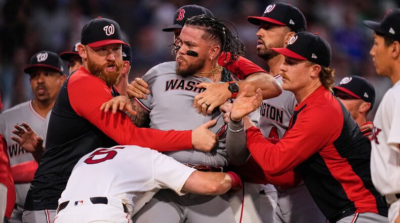 Washington Nationals' Andrés Chaparro, center, is held back as tempers flare during the fourth inning of a baseball game against the Boston Red Sox, Tuesday, June 30, 2026, in Boston. (AP Photo/Charles Krupa)