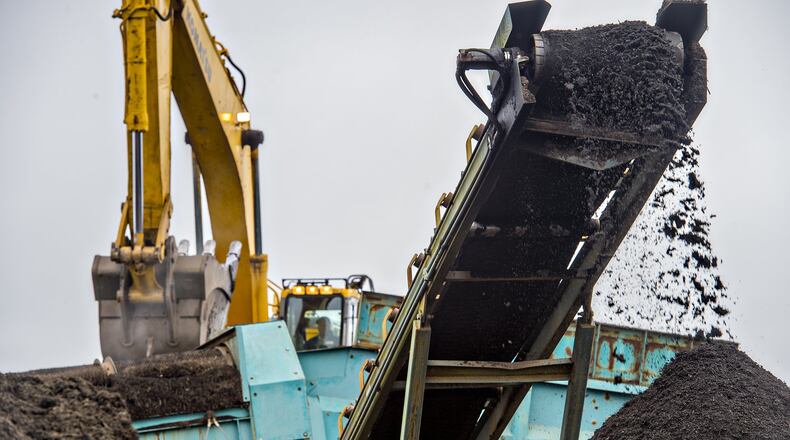 An excavator moves piles of dirt and debris into a mulching machine at the Seminole Road Landfill last week. In 2011, Fleet Maintenance Director Greg Brake had a truckload of the county’s mulch delivered to his house for free, something DeKalb’s special investigators were honing in on before their probe was cut short. Delivery normally costs $7.50 per cubic yard. JONATHAN PHILLIPS / SPECIAL