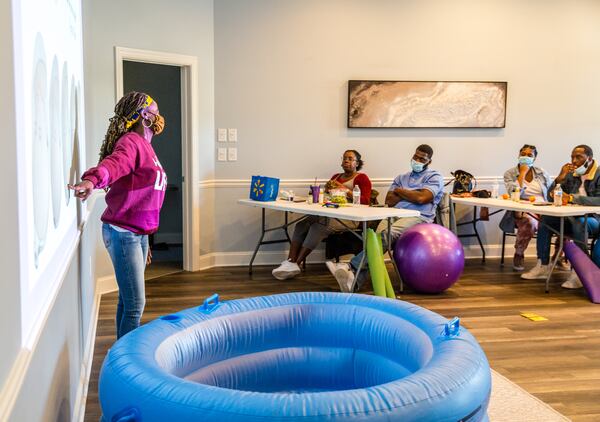 Certified nurse-midwife Christine Taylor, owner of the practice Birth by Grace, holds a birthing class for a few couples in Peachtree City on Saturday, Jan. 23, 2021. The families are planning home births under the guidance of Taylor and doula Dawn Hutcherson.  (Jenni Girtman for The Atlanta Journal-Constitution)