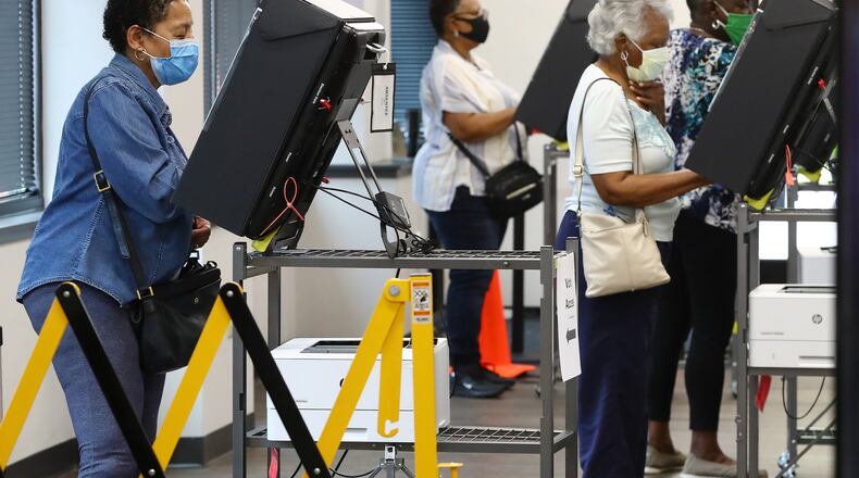 Voters wear masks and cast their ballots at least six feet apart the first day of early voting at the Cobb County Board of Elections & Registration on Monday afternoon, May 18, 2020, in Marietta. Curtis Compton ccompton@ajc.com