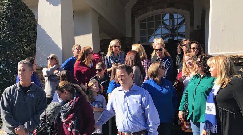 Parents in Forsyth County leave a meeting where they announced they were suing the county over its redistricting of high school students in the south end of the county. “We just object to how this process was done,” said parent Chris Reilly, pictured front and center in the blue shirt. Marlon A. Walker.