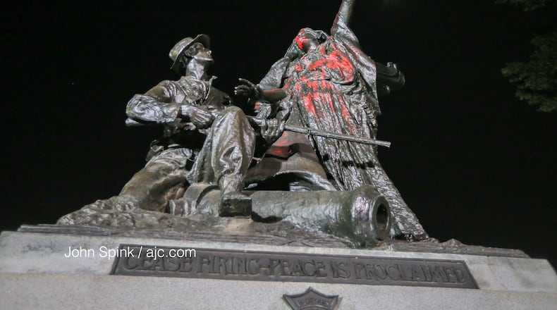 Protesters climbed the Peace Monument in Piedmont Park, spray painted it and tried tearing it down. The structure was erected in 1911 to champion unity and reconciliation. John Spink/AJC