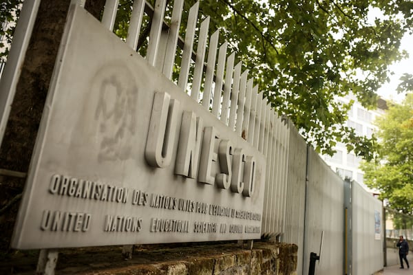 A man enters the UNESCO headquarters Tuesday, July 22, 2025 in Paris. (AP Photo/Thomas Padilla)