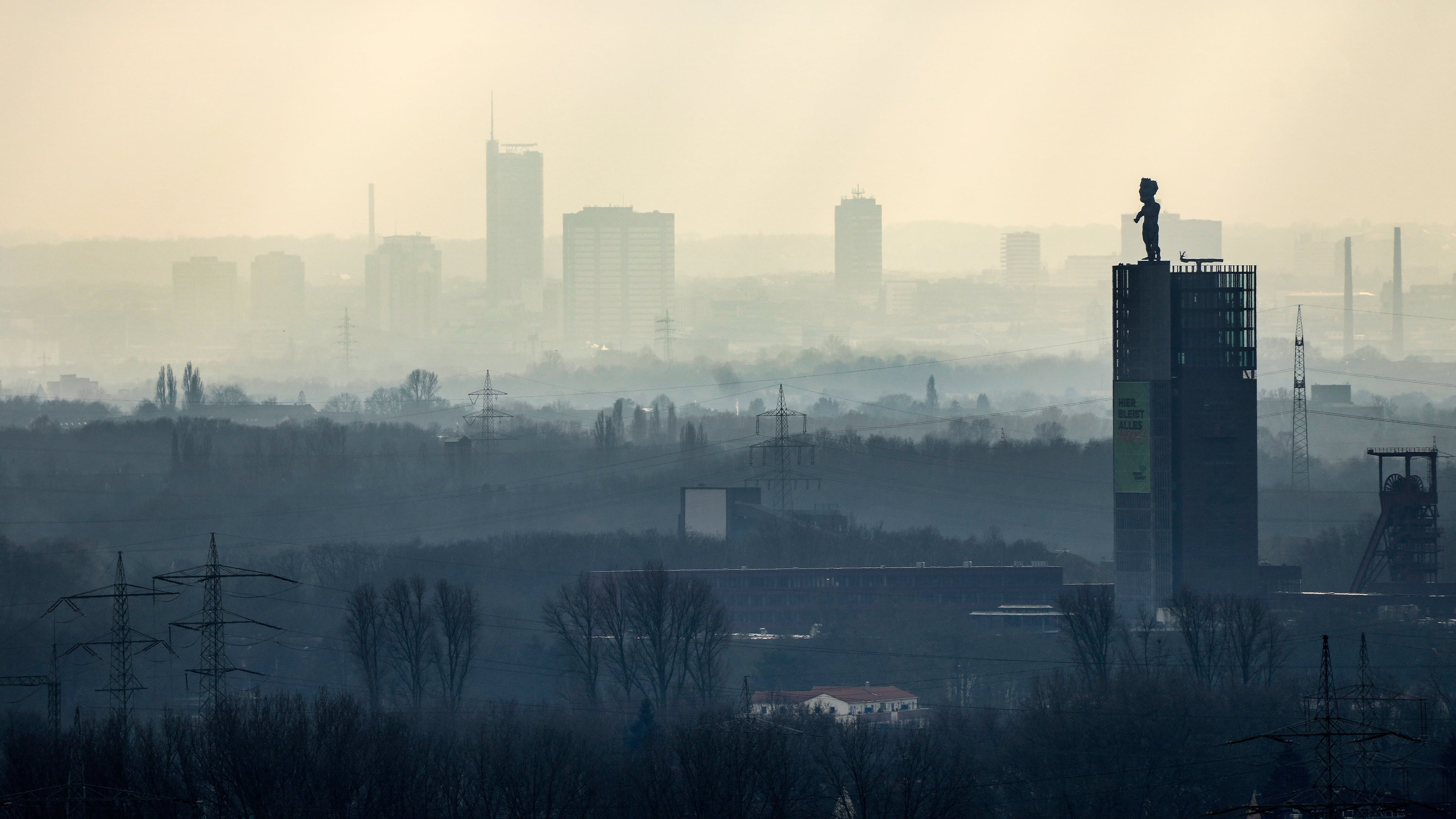 FILE - The city center of Essen is seen through the fog as German Federal Environment Agency warns about poor air quality in Germany due to fine dust pollution, Essen, Germany, Feb. 12, 2025. (AP Photo/Martin Meissner, File)