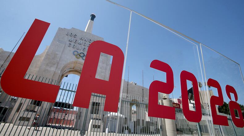 The Los Angeles Memorial Coliseum is framed by signage after the city was officially awarded the rights to host the 2028 Olympic Games on September 13, 2017. (Luis Sinco/Los Angeles Times/TNS)