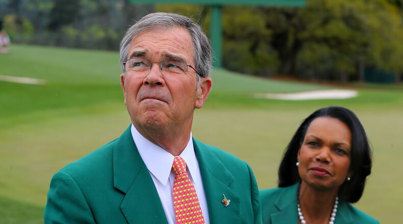 Augusta National Chairman Billy Payne and former Secretary of State Condoleezza Rice do some old-school weather analysis during the 2014 Masters. (Curtis Compton/ccompton@ajc.com)