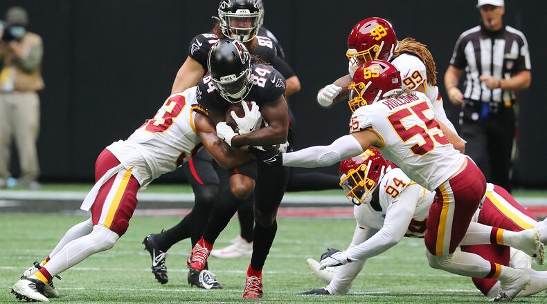 Atlanta Falcons running back Cordarrelle Patterson runs through Washington Football Team defenders for a first down during the first quarter on Sunday, Oct. 3, 2021 at Mercedes Benz Stadium in Atlanta. (Curtis Compton/Atlanta Journal-Constitution/TNS)