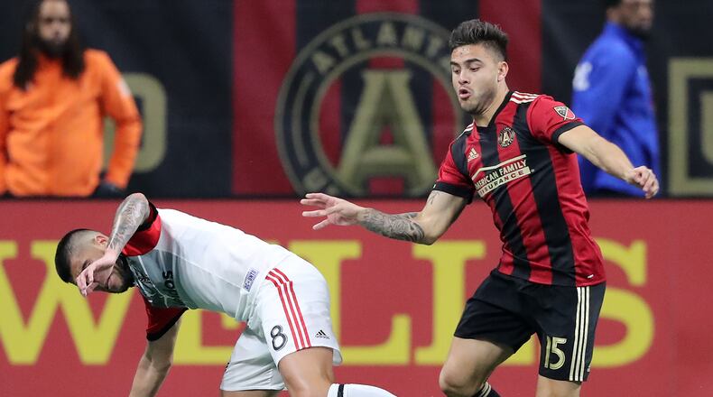 Atlanta United forward Hector Villalba wins the battle for the ball with D.C. United player Ulises Segura during the second half in a MLS soccer match on Sunday, March 11, 2018, in Atlanta.
