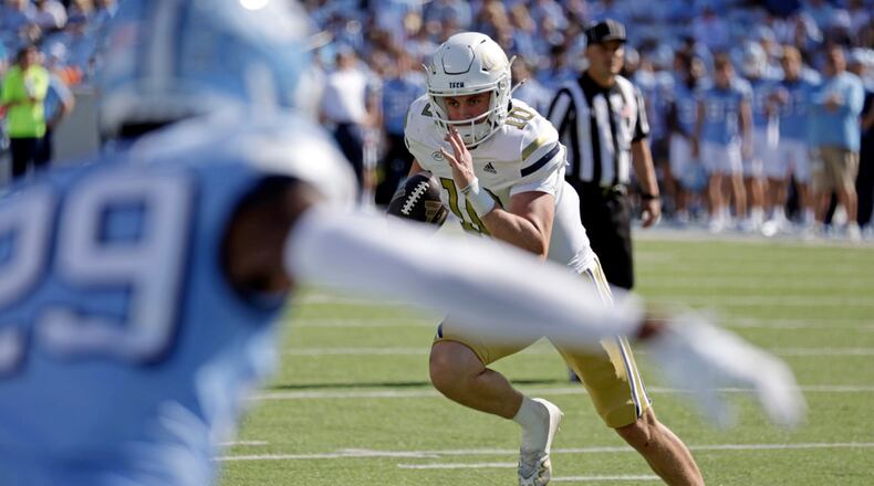 Georgia Tech quarterback Haynes King (10) evades North Carolina defensive back Marcus Allen (29) as he runs for a touchdown during the second half of an NCAA college football game, Saturday, Oct. 12, 2024, in Chapel Hill, N.C. (AP Photo/Chris Seward)