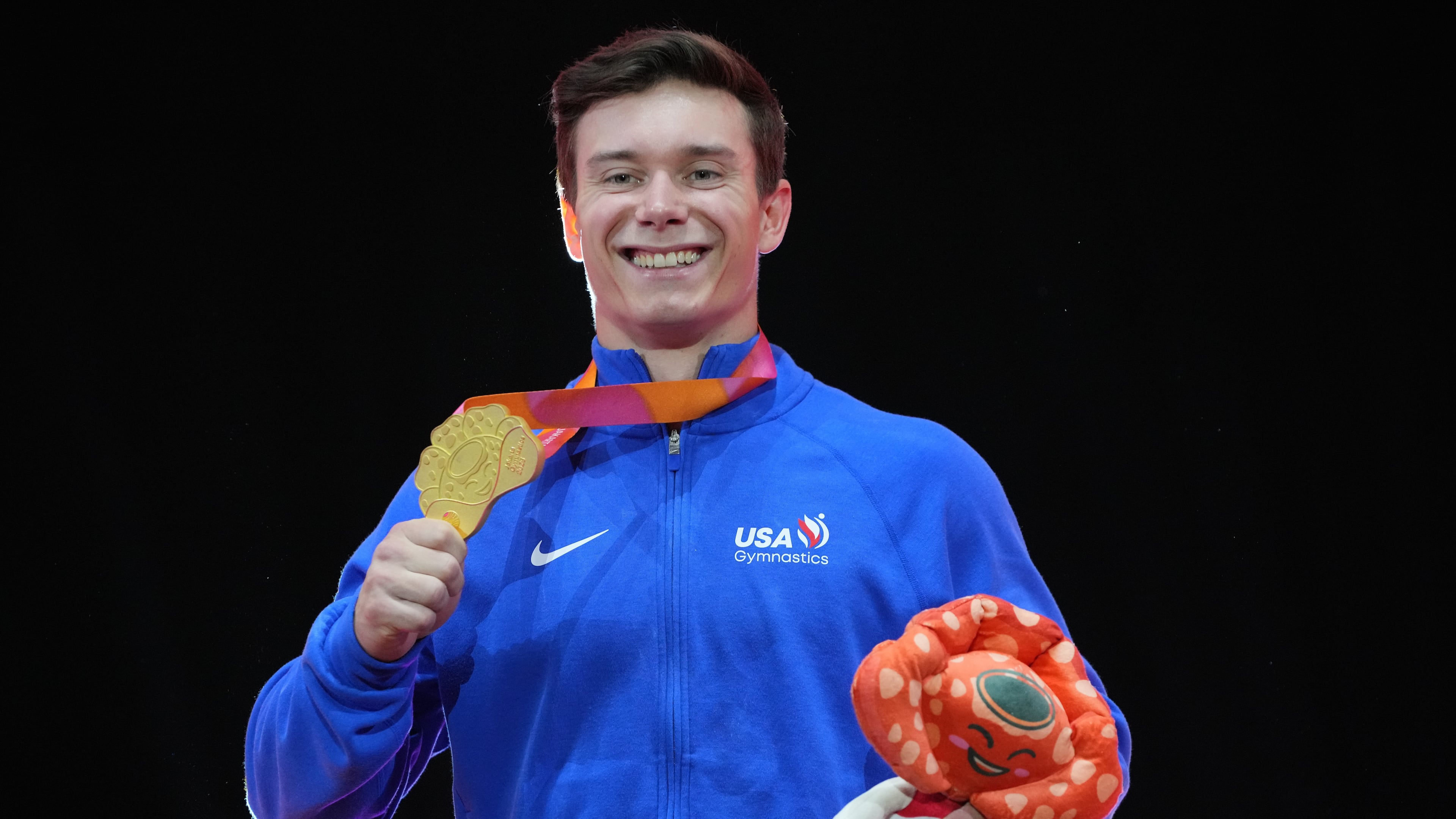 Gold medal winner, Brody Malone of the United States, poses on the podium after competing in the men's horizontal bar final during the 53rd Artistic Gymnastics World Championships in Jakarta, Indonesia, Saturday, Oct. 25, 2025. (AP Photo/Achmad Ibrahim)