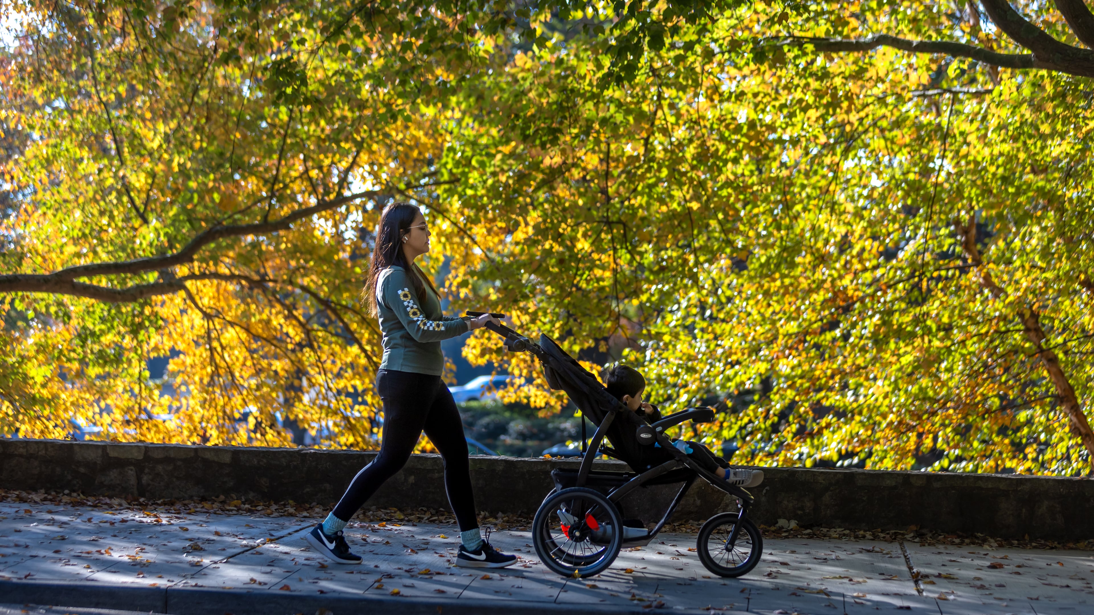 This week will be cooler than usual in metro Atlanta, much like last October when Gabriela Santos took 2-year-old Aiden, whom she frequently babysat, for a stroll. (File/AJC)